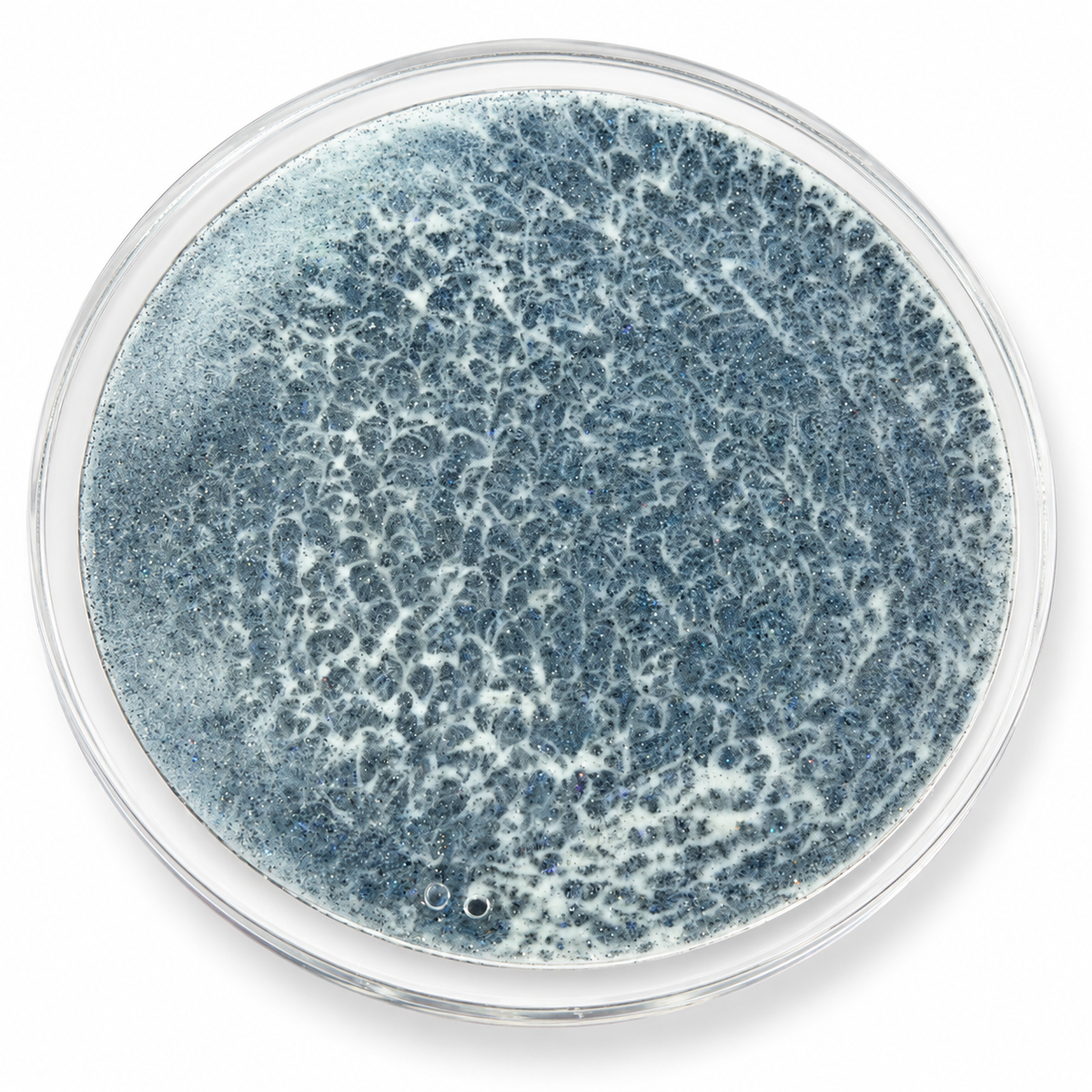 Ocean Tide moving sand art coaster with a clear round rim and blue-gray wave pattern on a white background